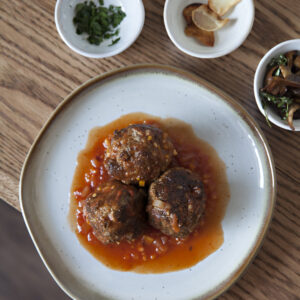 Meatballs in spicy red sauce. Recipe by chef Amber Lynne
